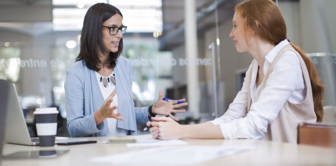 Coaching and advise, two business woman working together.