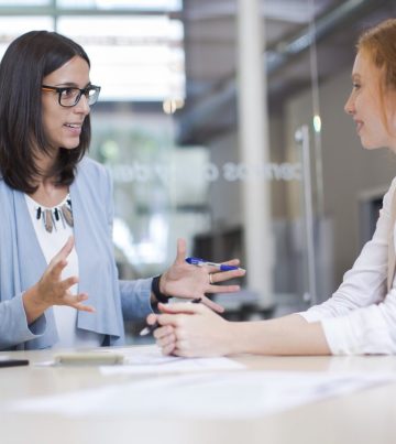 Coaching and advise, two business woman working together.